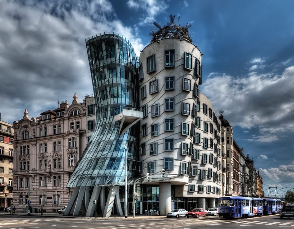 I have about 500 shots of the Dancing House in Prague from every possible angle, portrait and landscape. They've been sitting on my disk for almost 2 years. I didn't know how to process them as the light was not great and an early attempt using Photomatix was a disaster...ISO 100, 14mm, f6.3, (1/1600, 1/400, 1/100 secs)...I chose the f-stop so that I would get fast enough speed for the moving cars. Blended and tonmeppaed in Photomatix using Details Enhancer. Reduced noise in Imagenomics Noiseware. Carefully straightened the vertilcals using the Lens Correction filter in PS as the whole point if the building is it's vertical lines. Used the Freaky Details technique to get lots of details on the windows, etc. Used Nik Viveza to reduce the white glow around the building that was left over from Photomatix processing (masking the clouds). Used 15% Nik Glamour Glow to reduce the harshness of the Photomatix and Freaky Details.